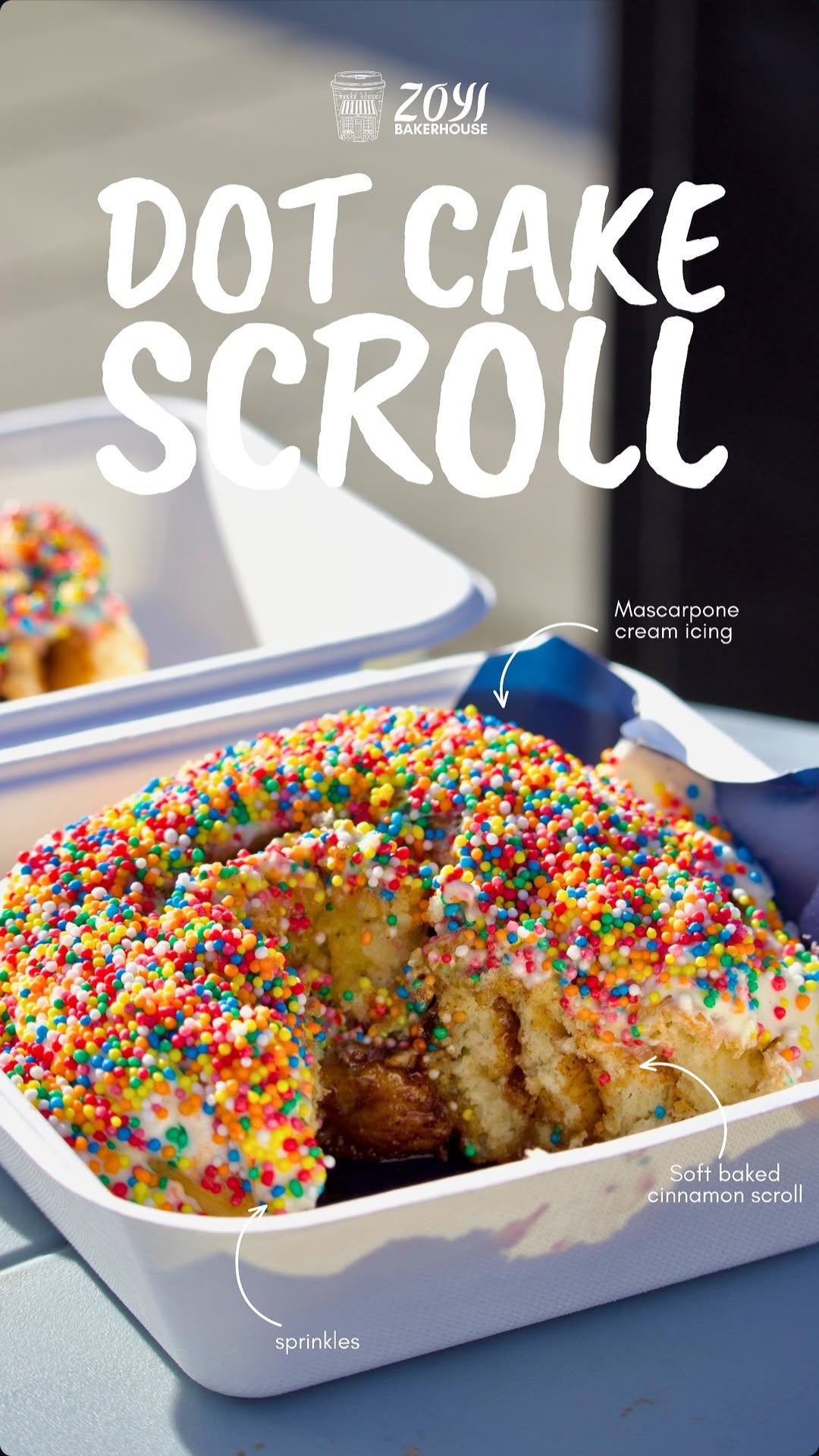 Dot Cake Scroll, iced and topped with sprinkles, in a Zoyi BakeHouse takeaway box